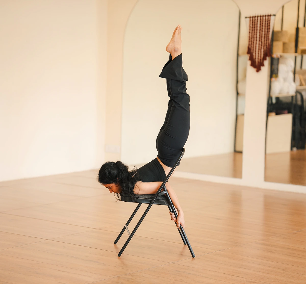 Students practising yoga in the bright hall at Samsara Yoga Studio